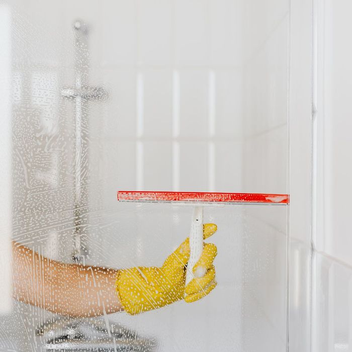 Cleaning shower glass with squeegee